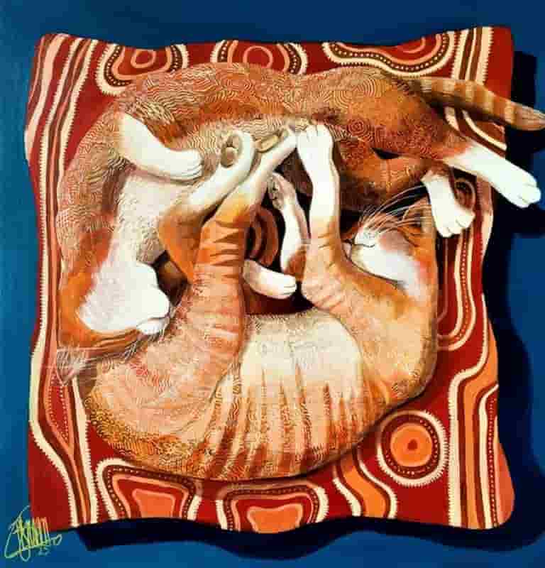 Two cats entwined on a cushion