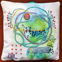 Hand embroidery on painted  linen expressing the joy of life
