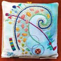 Hand embroidery on painted  linen expressing the joy of life