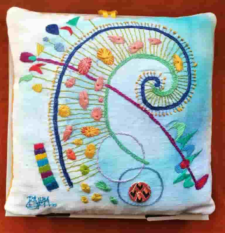 Hand embroidery on painted  linen expressing the joy of life