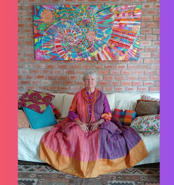 Photo of Bridget March artist  with one of her large paintings