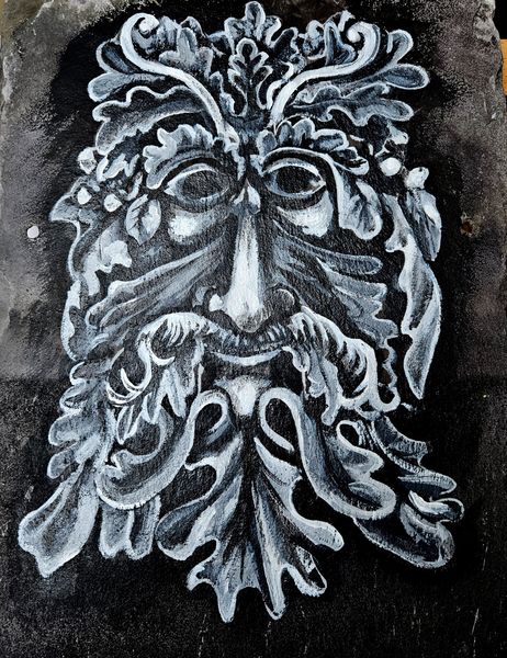 The face of Cerenus, the green man. Painted on slate.