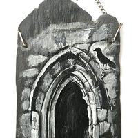 A crow stands on the stonework around a Gothic arch. Slate painting.