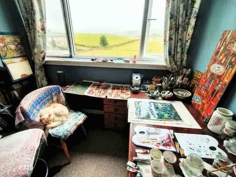 My artroom, my cat asleep on the chair, and a view of the Yorkshire Dales through the window.