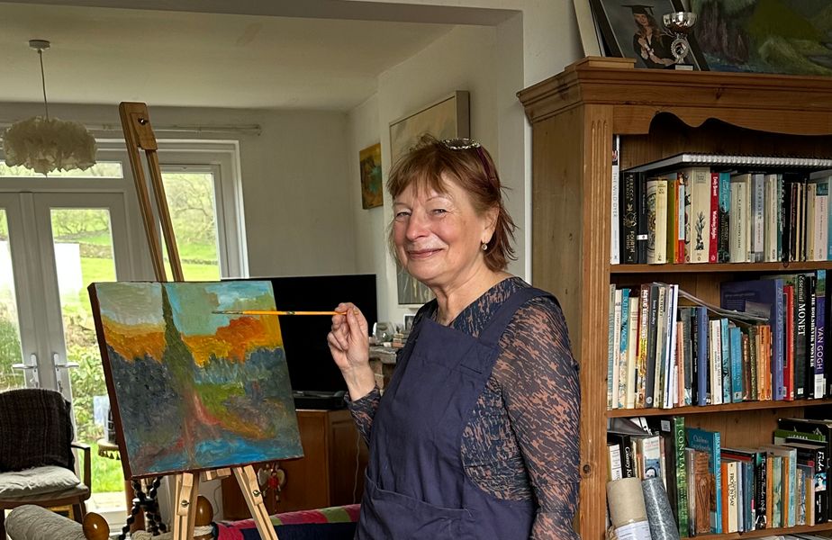 Joy Bowhay at her studio painting
