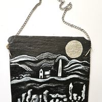 A stone wall, a mill and a silver moon on slate