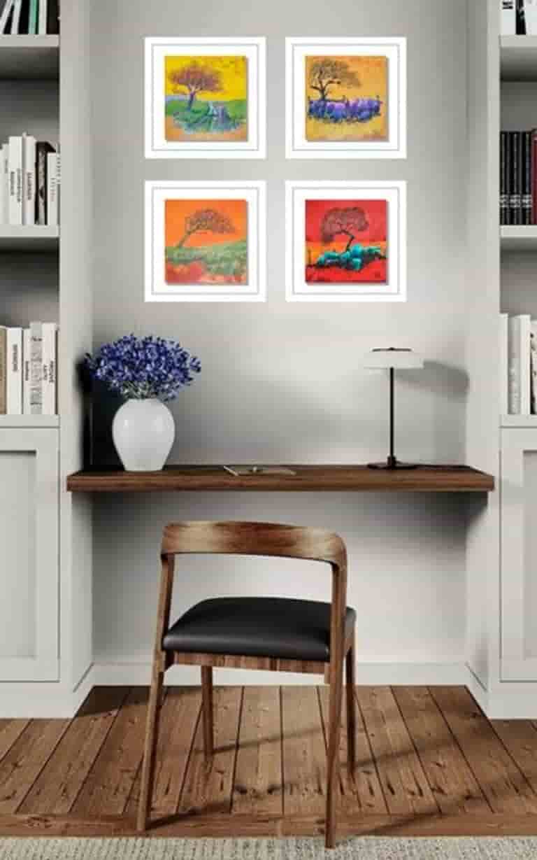 Set of four small tree paintings above a desk