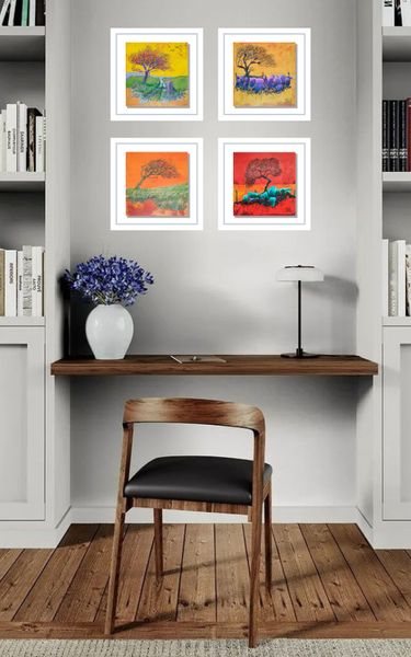 Set of four small tree paintings above a desk