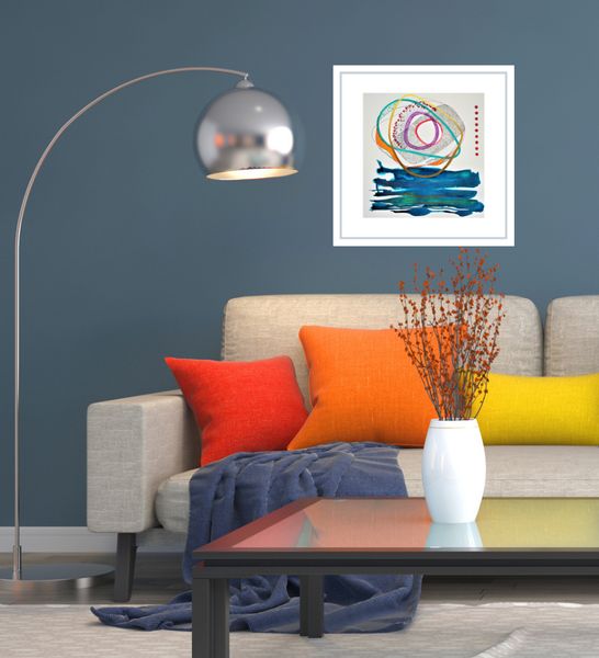 Framed watercolour in a roomset with beige sofa and colourful cushions