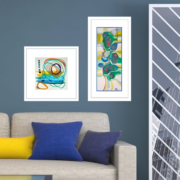 framed watercolours in a roomset with cream sofa
