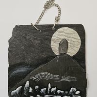 Slate painting of a standing stone on a hill