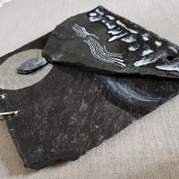 Small Slate relief painting with chain for wall hanging.
