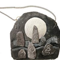 Standing stones on a hill illuminated by a silver moon