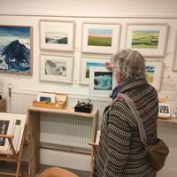 Selecting a small piece of art to add to her collection