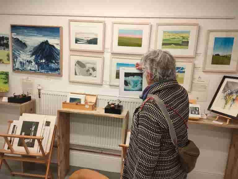 Selecting a small piece of art to add to her collection