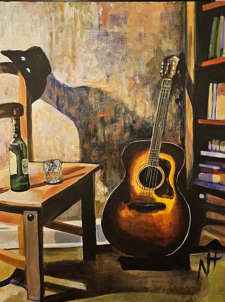 A guitar leans against a wall. A bottle of whiskey and a glass sits on a chair. Shadows lengthen in the room